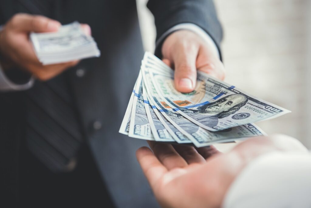 client handing over money to a home inspector